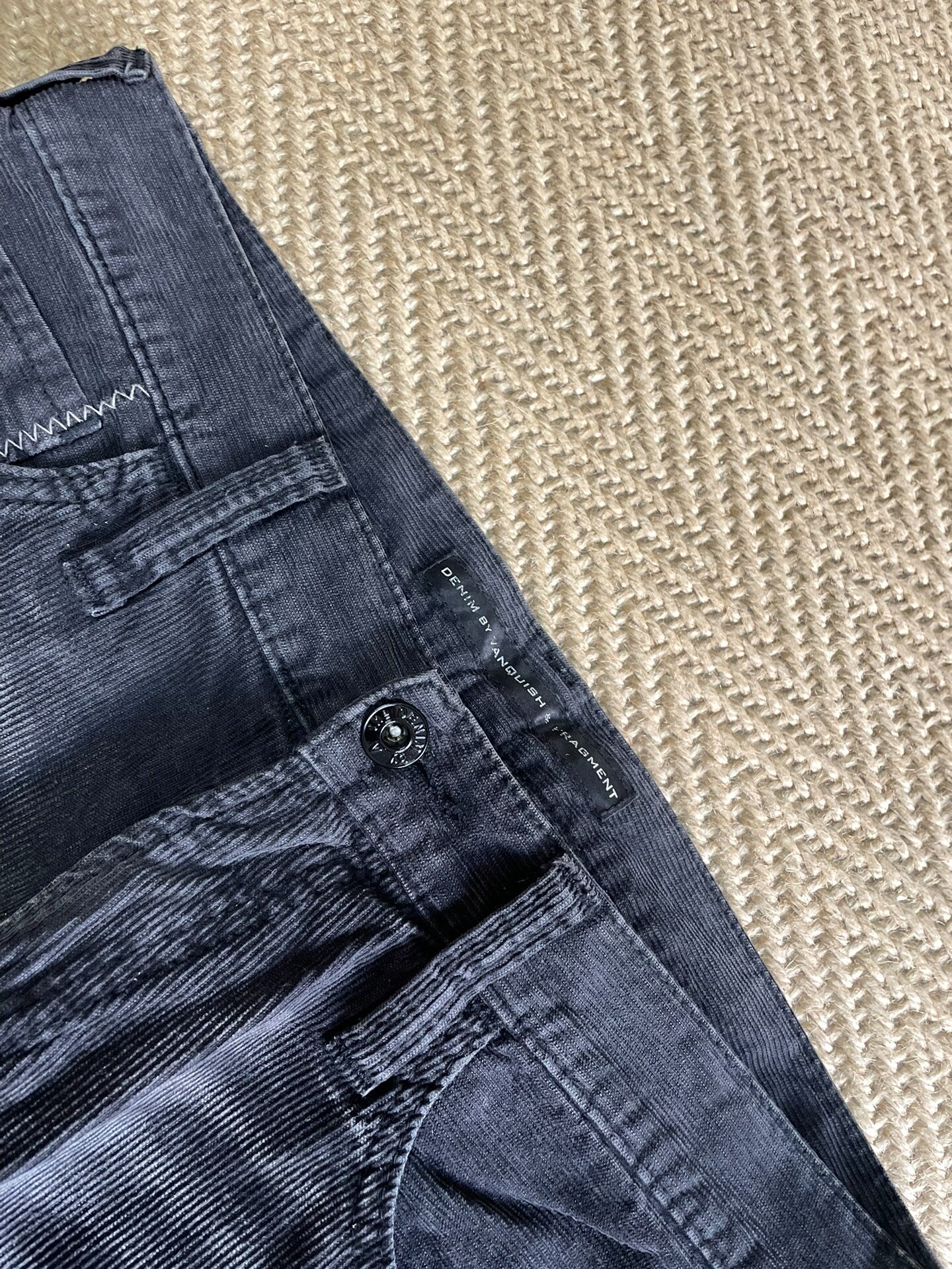 DENIM BY VANQUISH & FRAGMENT Washed Distressed Corduroy Pants — label