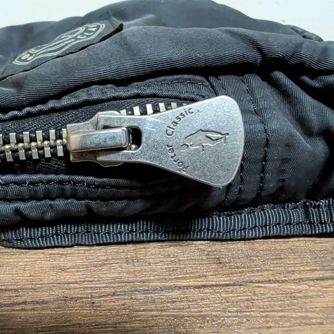 PORTER Classic Black Damaged Nylon Bag — label
