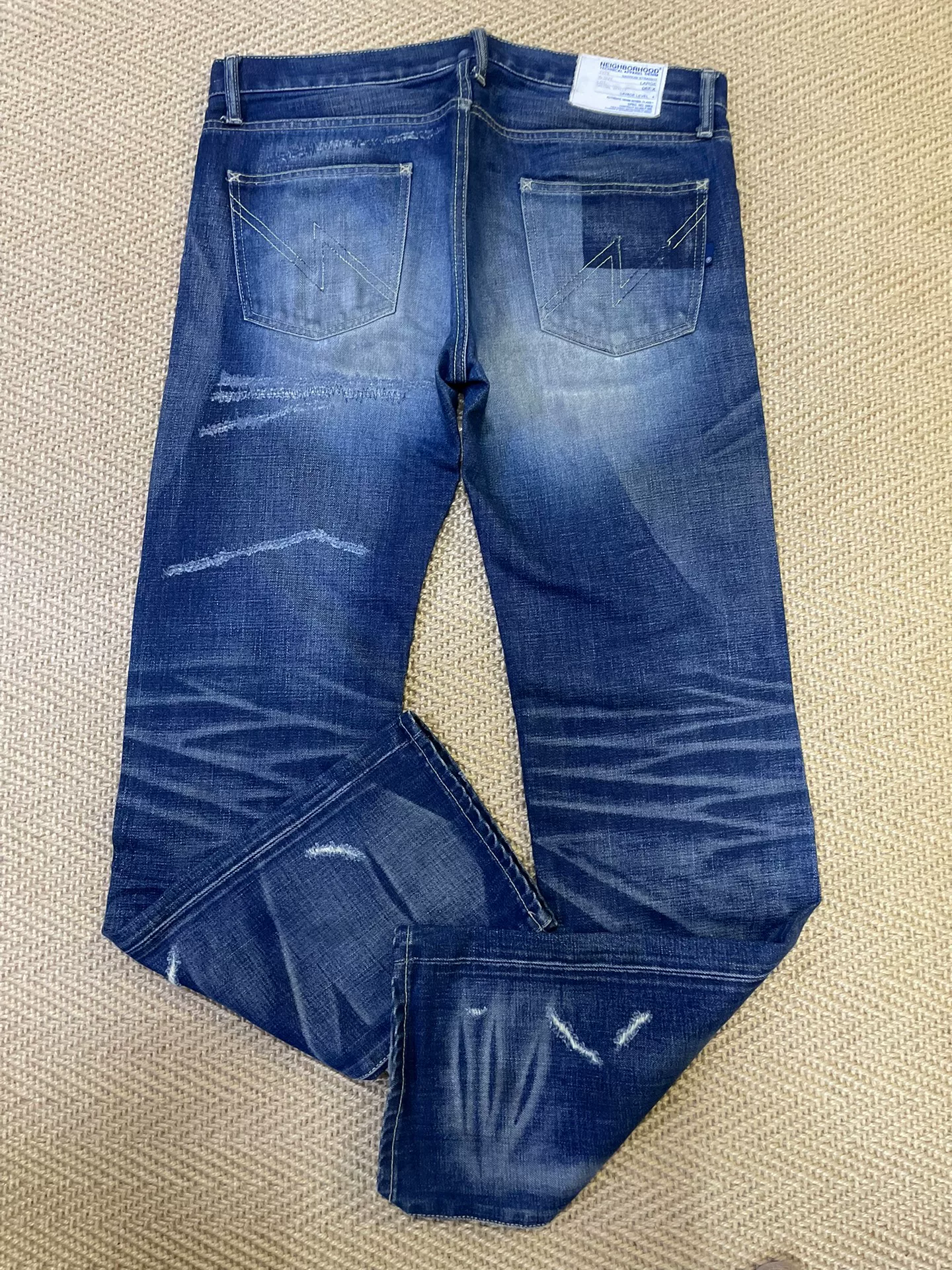 NEIGHBORHOOD Washed Distressed Jeans — label