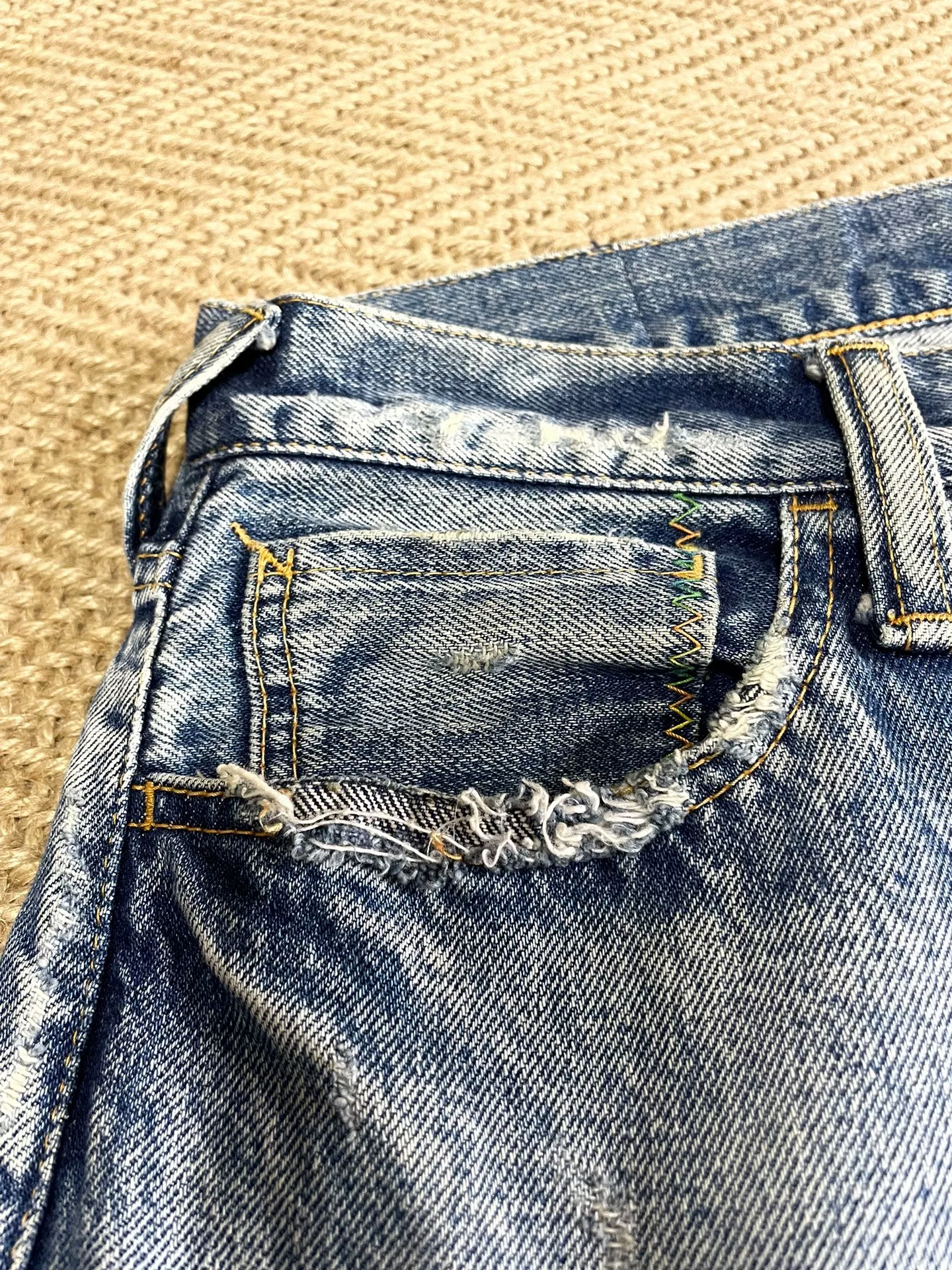 Vanquish & Fragment Distressed Washed Jeans — label