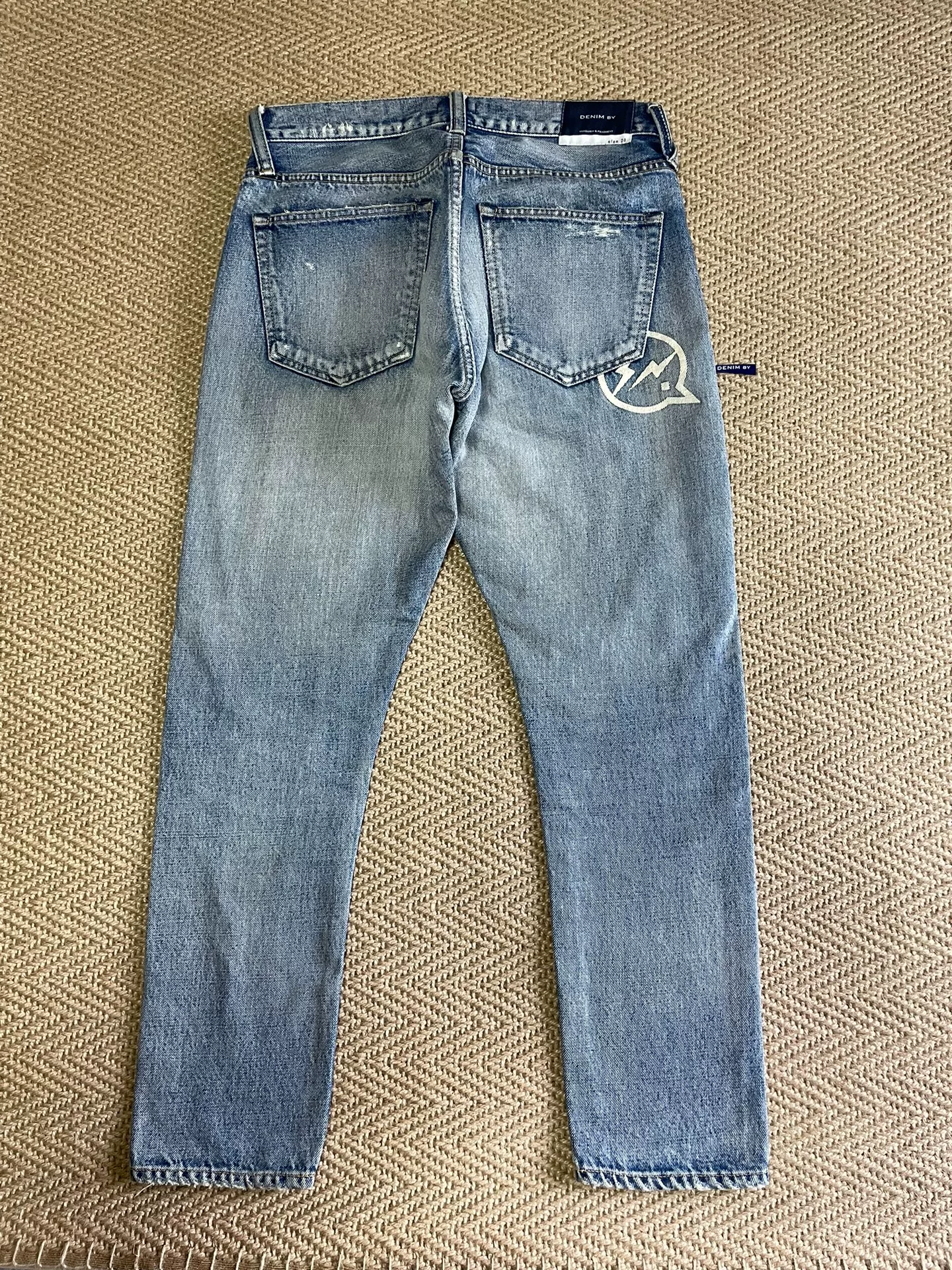 Vanquish & Fragment Distressed Washed Jeans — front