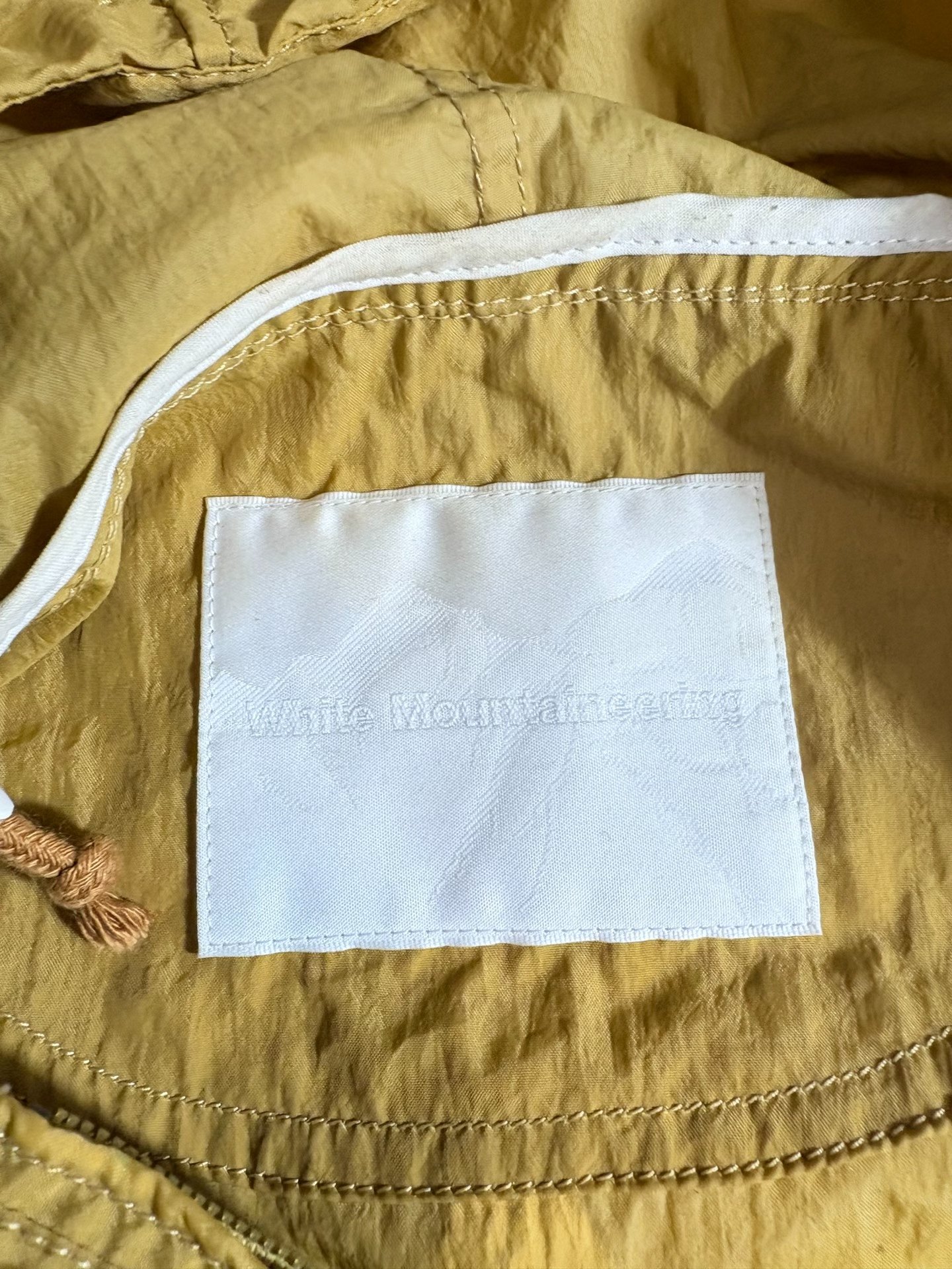 White Mountaineering Jacket — label