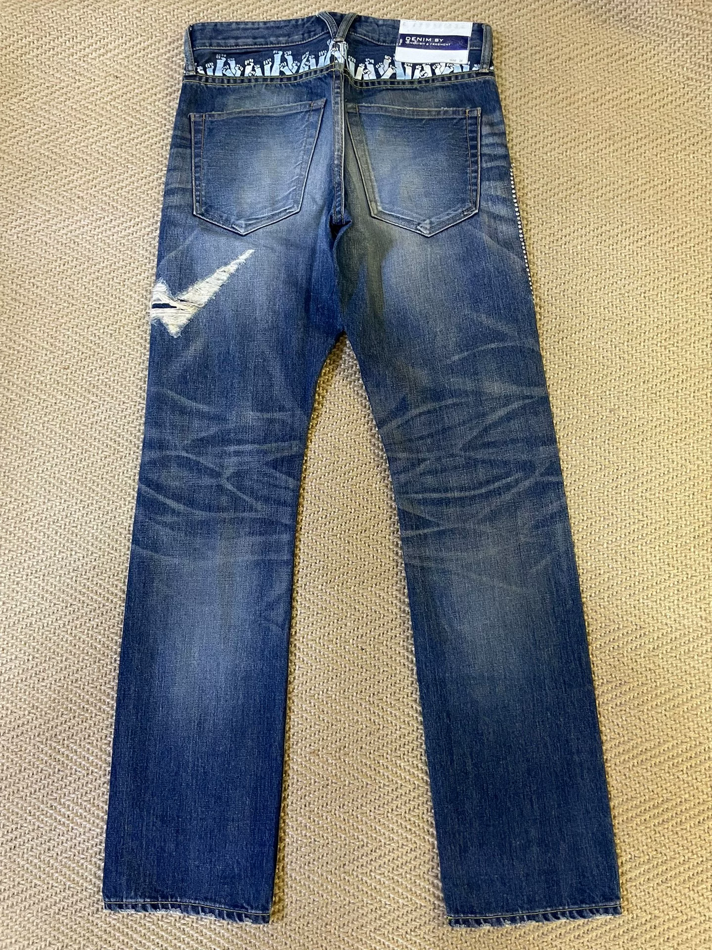 Vanquish & Fragment Distressed Lightning Jeans — front