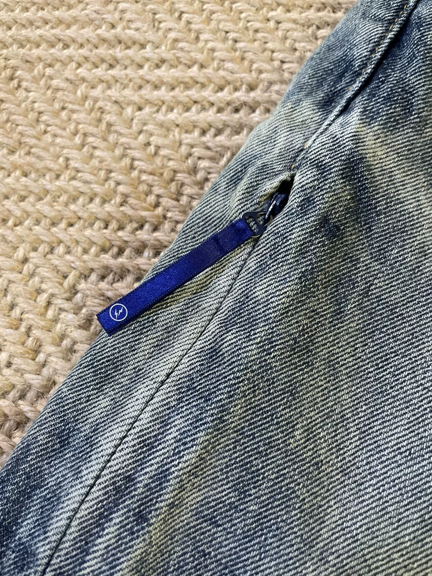 Vanquish & Fragment Distressed Denim Jeans — label