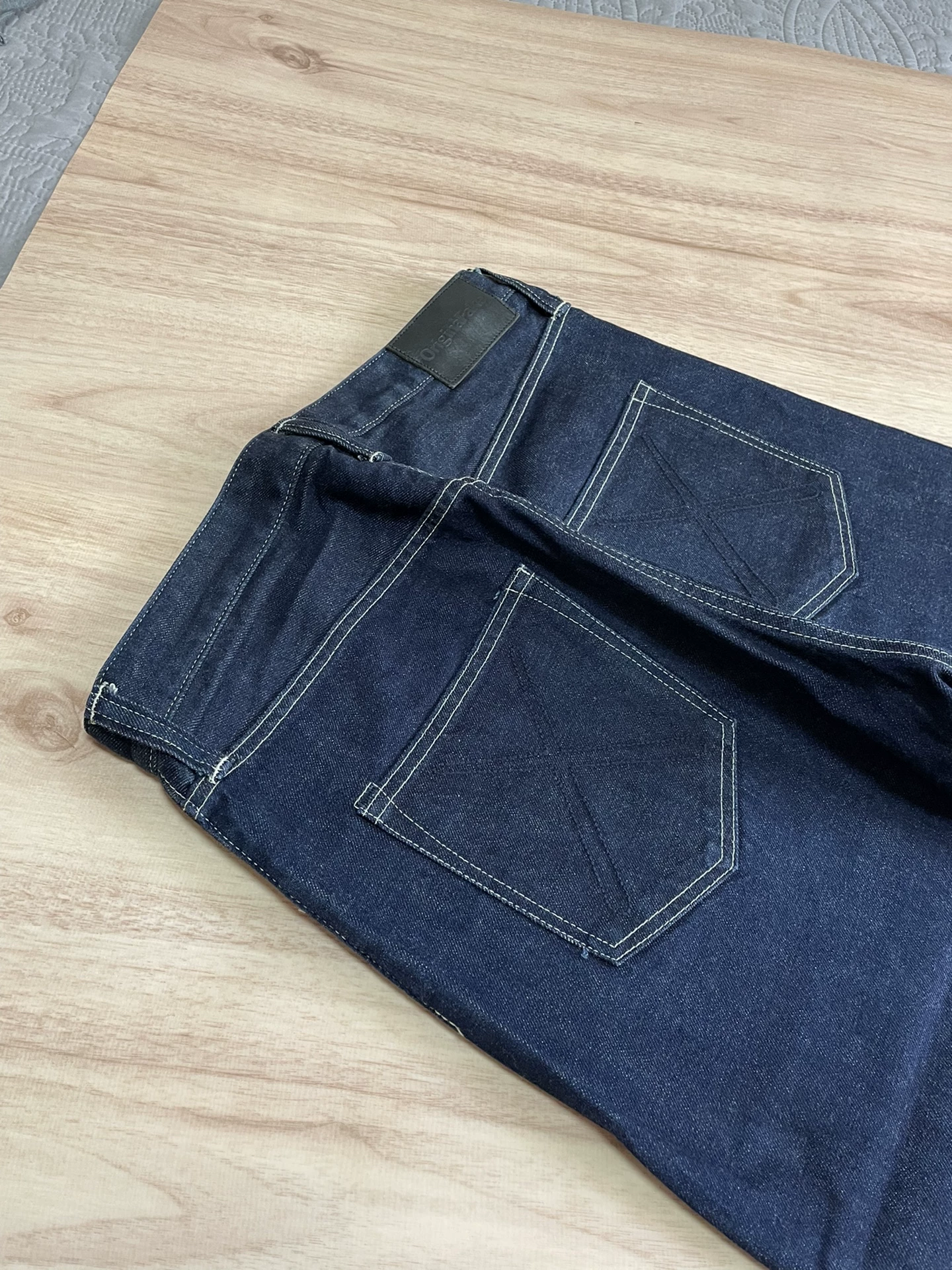 OriginalFake KAWS Raw Denim Jeans — label