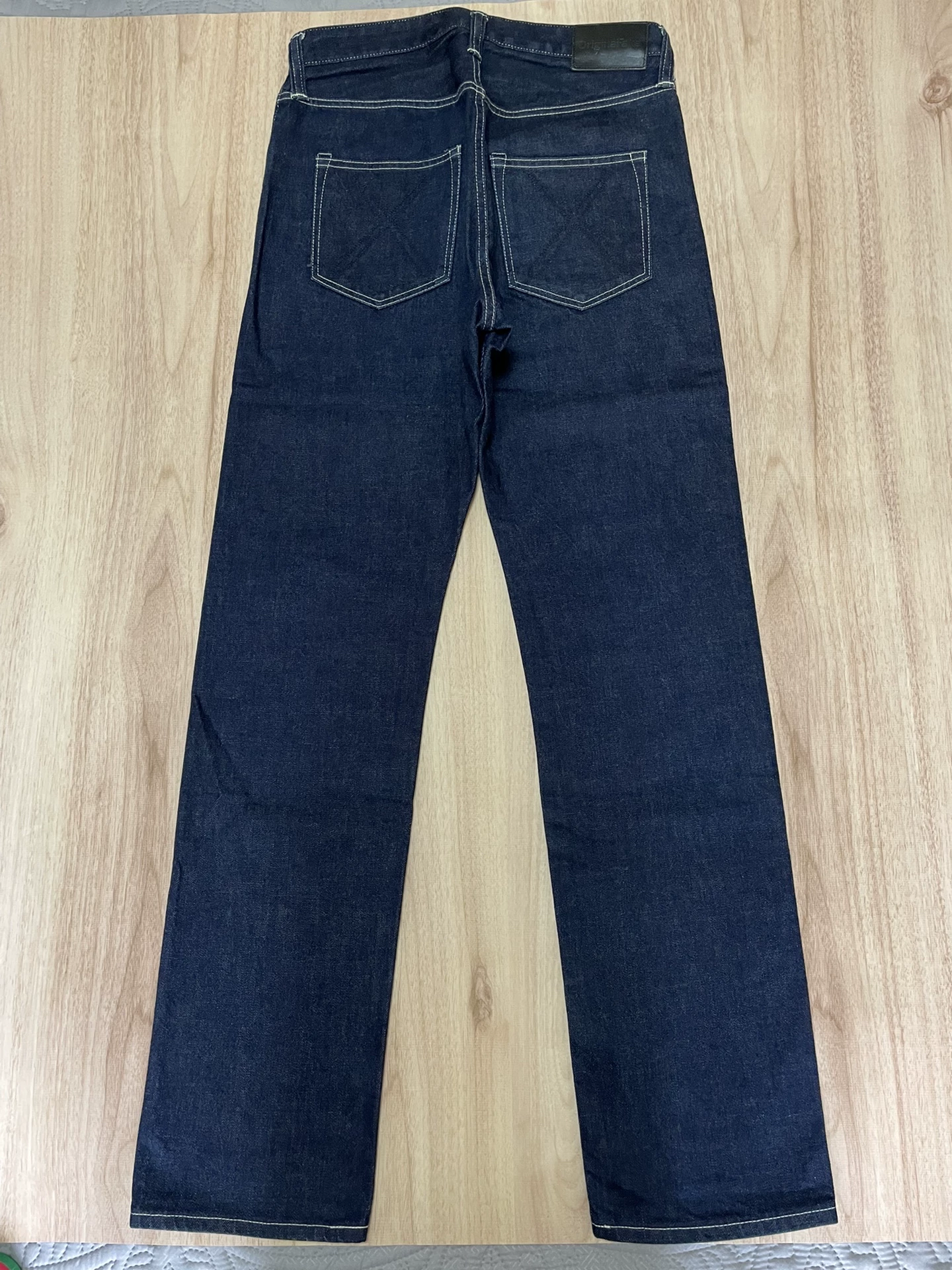 OriginalFake KAWS Raw Denim Jeans — front