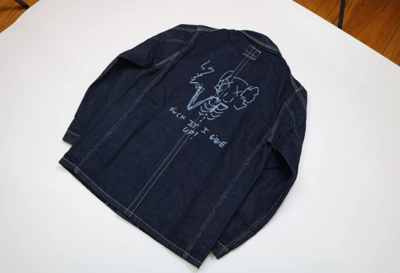 OriginalFake KAWS Denim Jacket — label