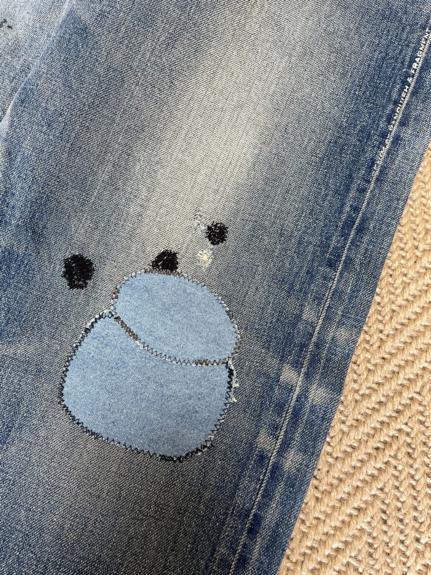 Vanquish Fragment Denim Distressed Jeans — label