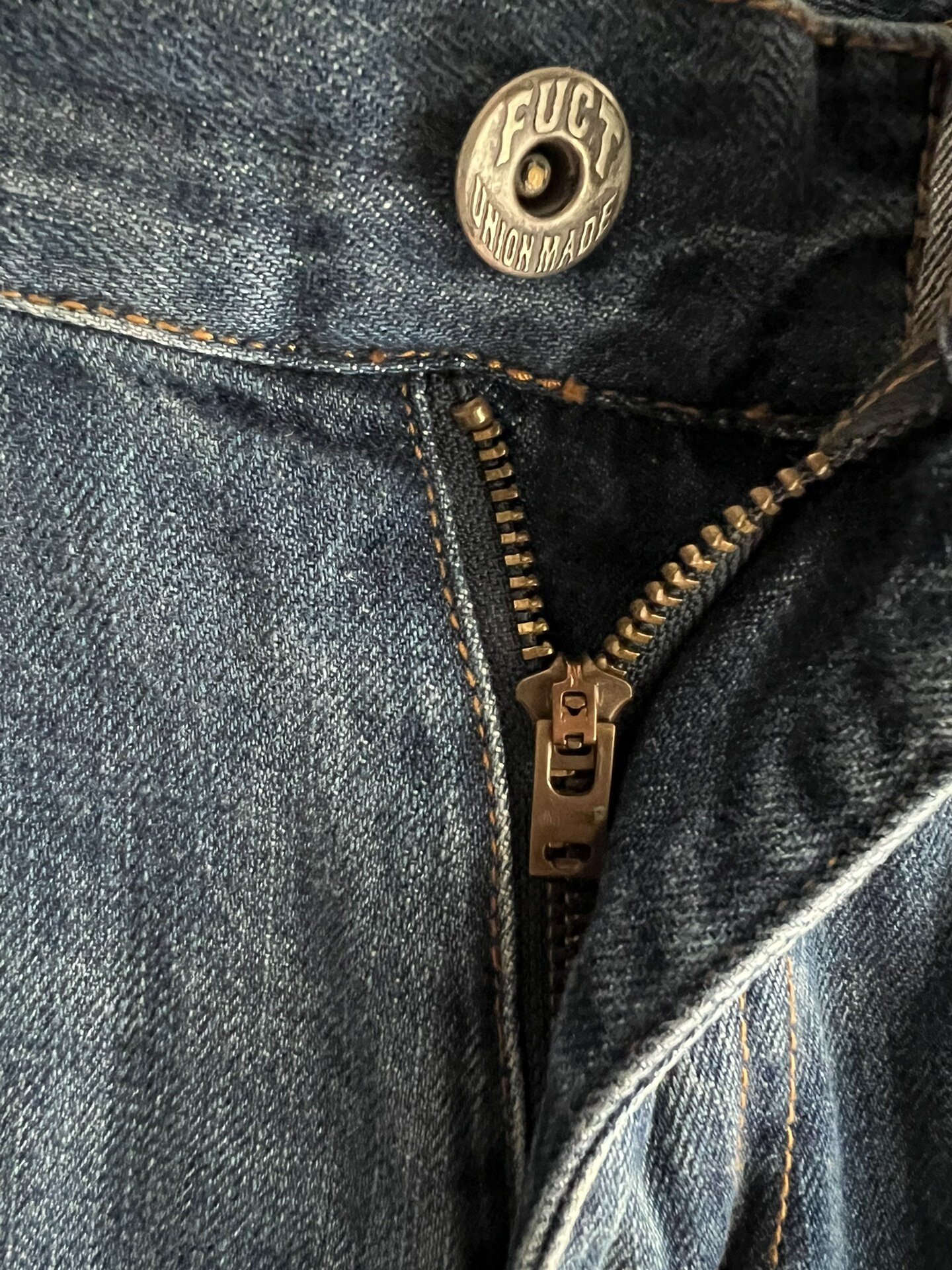 FUCT Vintage Washed Distressed Jeans — label