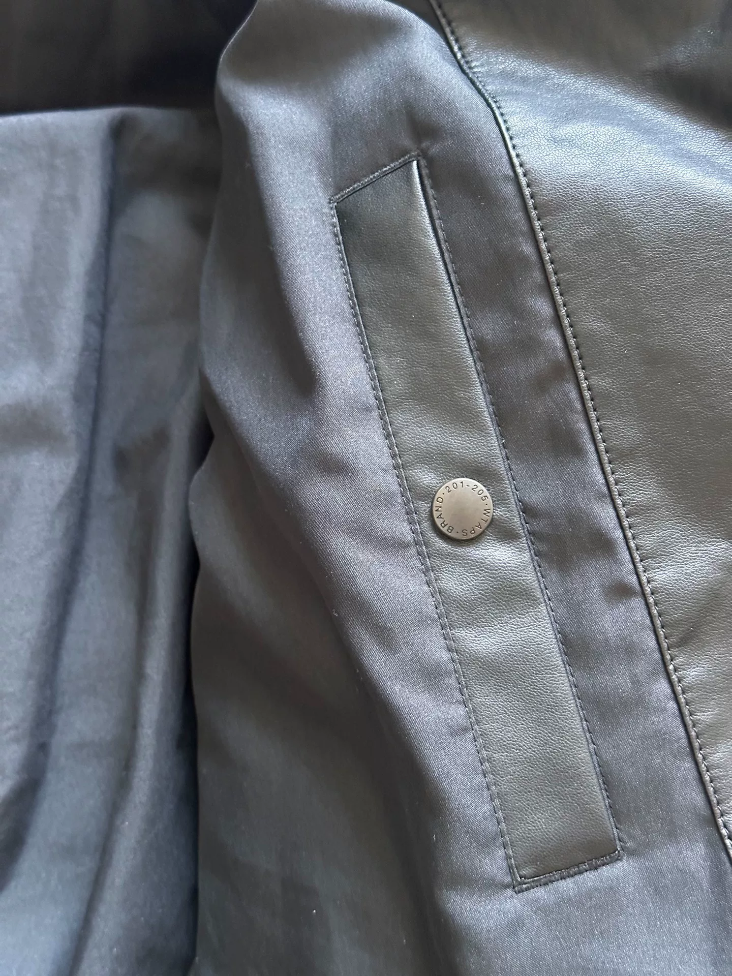 WTAPS Synthetic Leather Puffer Jacket — label