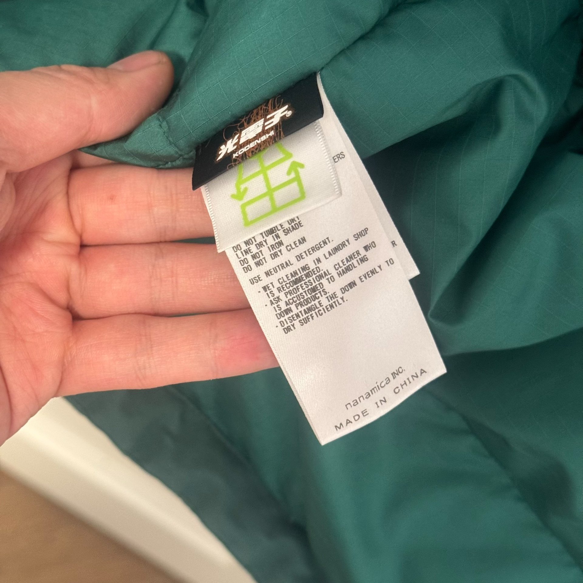 The North Face Green Hooded Down Jacket — label