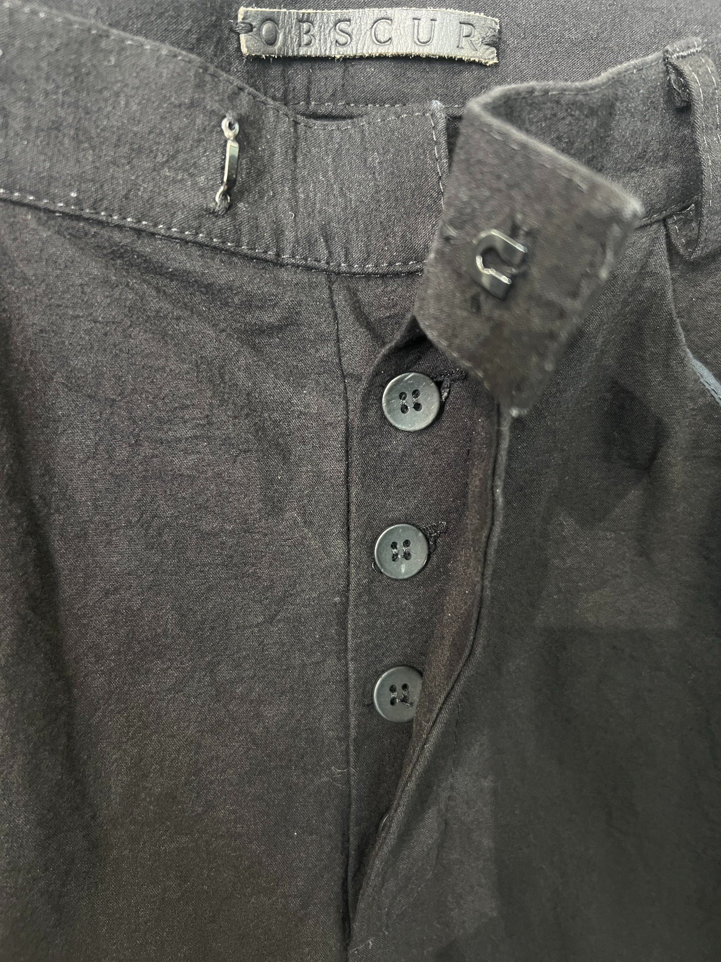Obscur Avant-Garde Dark Straight-Leg Pants — label