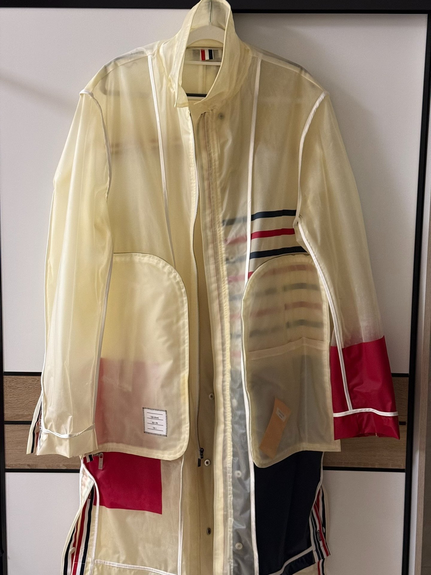 Thom Browne Transparent Stripe Rain Coat — label