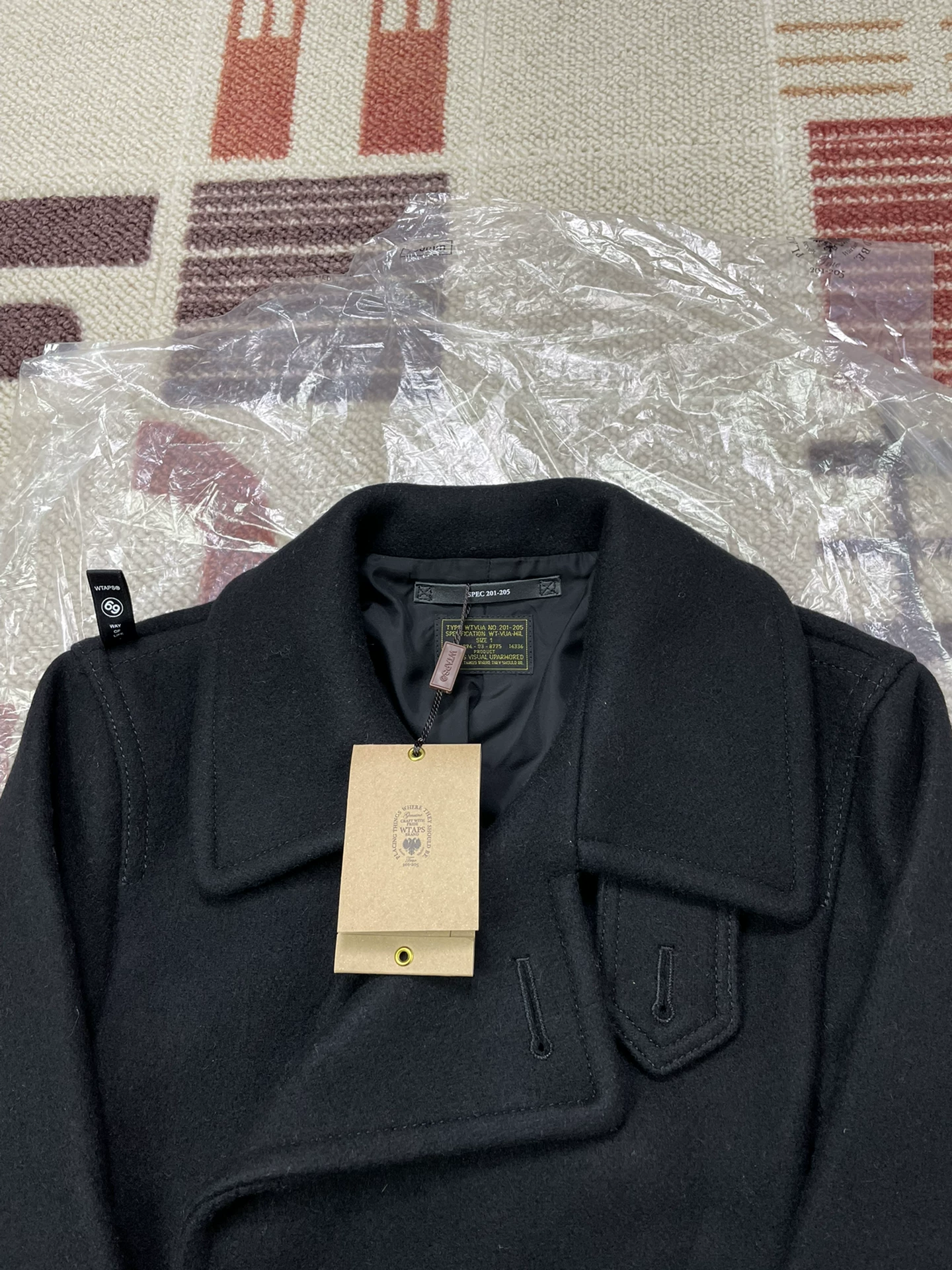 WTAPS Black Watch Coat — label
