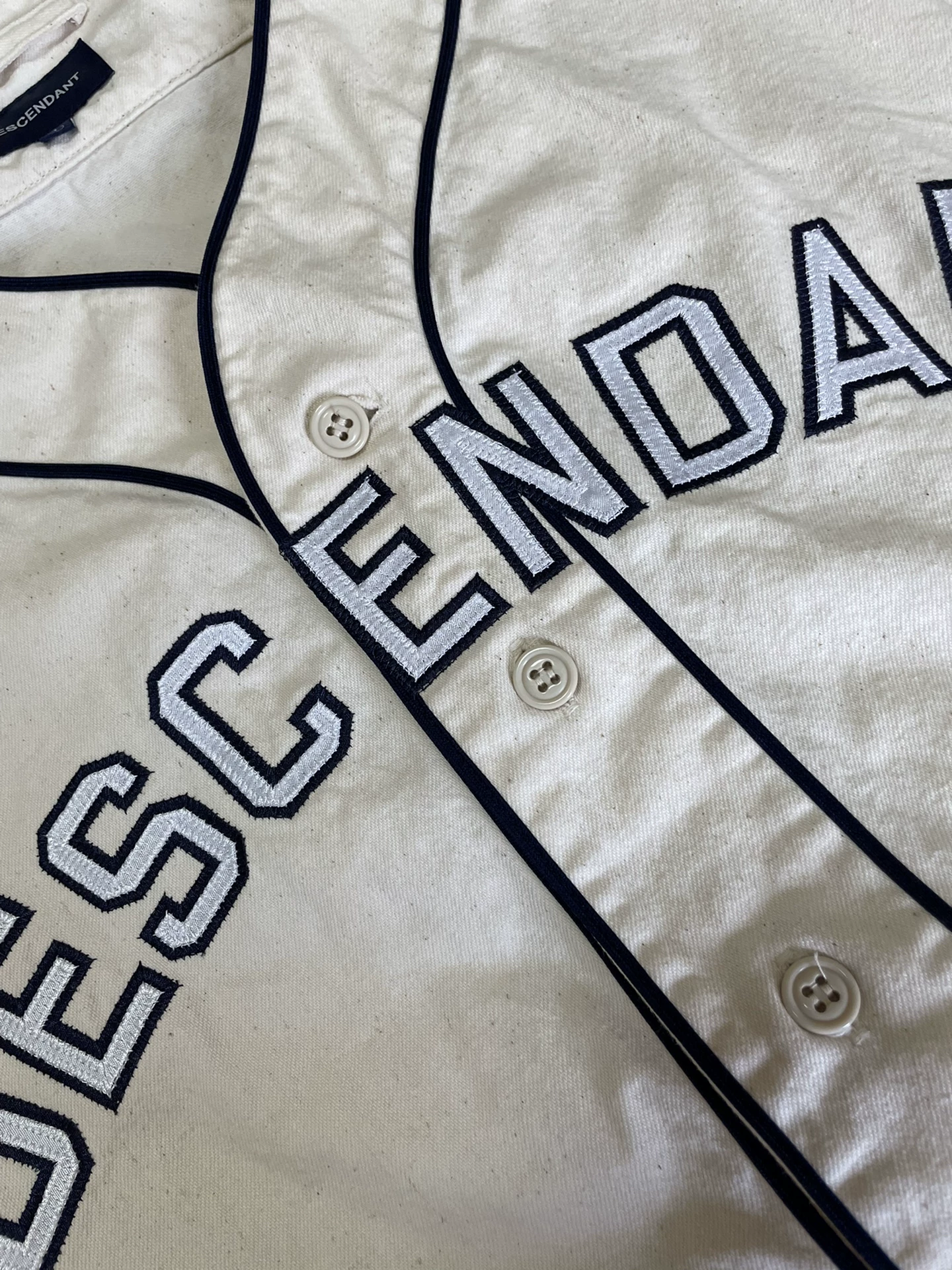 Descendant Bleek Collarless Baseball Cardigan — label