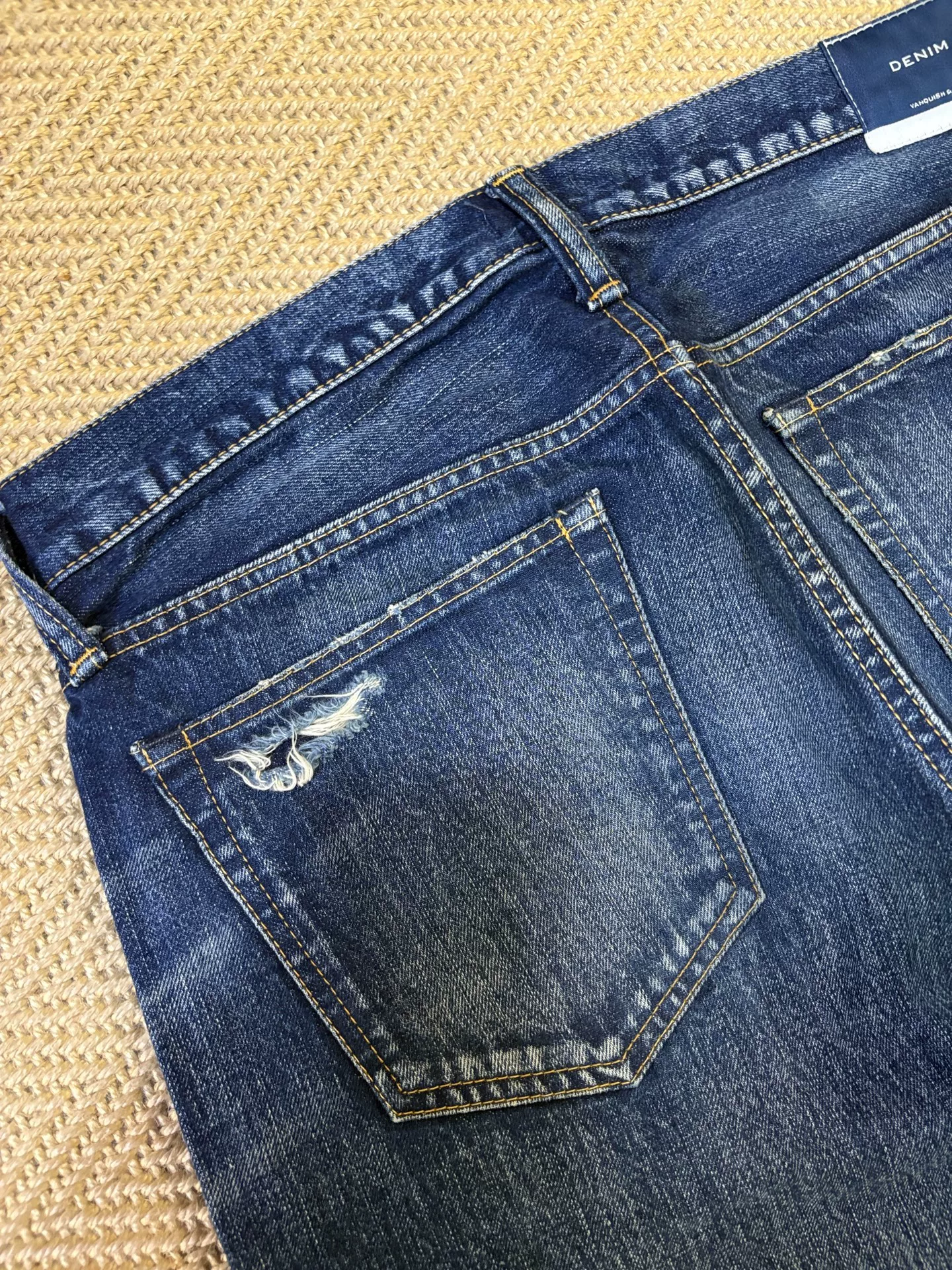 Vanquish & Fragment Washed Knife-Cut Cropped Jeans — label